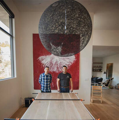 jose cruz with employee with custom wood table he created